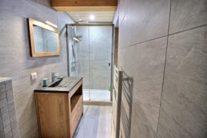 Salle d'eau douche lavabo mur pierre